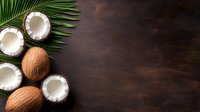 Fresh coconuts and palm leaves arranged on dark wooden background with copy space, overhead view of tropical food ingredients for healthy eating.