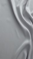 Smooth gray silk fabric with elegant flowing waves and soft shadows creating luxurious textile background for fashion and interior design projects.