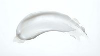 Creamy white cosmetic product smear or skincare lotion stroke isolated on white background, suitable for beauty and wellness design projects.