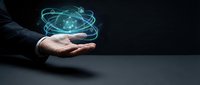Businessman hand presenting glowing digital globe with orbital rings on dark background for technology and global business concepts.