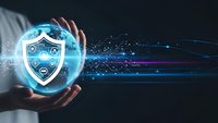 Businessman hands protecting glowing cybersecurity shield with digital network connections and data streams on dark background for tech protection.