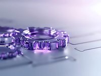 Purple metallic gear mechanism on light surface with soft focus and reflections, modern industrial engineering concept for technology backgrounds.