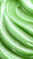 Soft swirling mint green cream texture with sparkling glitter particles creating dreamy abstract waves and curves for cosmetic and beauty backgrounds.