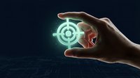 Hand holding glowing green target symbol with digital circuit background representing business goals, strategy planning and precision targeting.