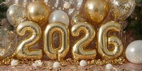 Golden 2026 number balloons with white and gold decorations on sparkling rose gold background for New Year celebration or anniversary party.