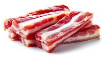 Raw pork belly strips with alternating layers of meat and fat, freshly cut and ready for cooking on white background.