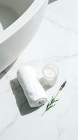 Rolled white towel with scented candle and lavender sprigs on marble surface, spa and wellness flat lay composition for relaxation and self-care.
