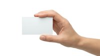 Hand holding blank white business card mockup on transparent background isolated for branding design presentation and corporate identity materials.