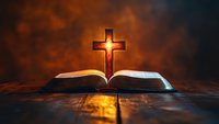 Open holy bible with glowing cross above pages against warm orange and dark background. Suitable for religious, spiritual, faith-based designs and worship materials.