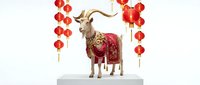 Golden goat statue wearing ornate red traditional costume with Chinese lanterns for Lunar New Year celebration and festive holiday decorations.