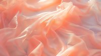 Soft flowing coral pink fabric with gentle folds and waves creates ethereal abstract background texture with delicate light and shadow play. Luxurious silk material.
