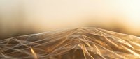 Abstract golden waves flowing in warm light creating elegant curves and smooth transitions for modern design backgrounds.