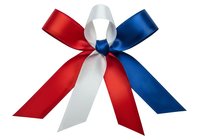 Patriotic ribbon bow with red, white, and blue satin ribbons arranged in a decorative knot on transparent background, suitable for holiday designs and promotional graphics.