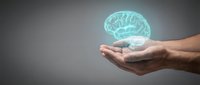 Hands holding glowing turquoise brain hologram representing artificial intelligence, mental health, neuroscience and cognitive technology concepts.