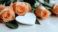 Peach roses with white heart decoration on light background, romantic floral composition with green leaves. Elegant Valentine's day or wedding concept.