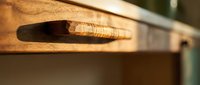 Handcrafted wooden furniture detail showing natural wood grain texture and artisan carpentry work for interior design and home decor projects.