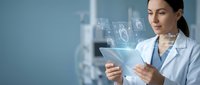 Female healthcare professional using digital tablet with holographic medical interface displaying heart and health data in modern clinical environment.