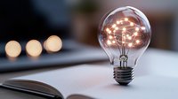 Glowing light bulb with illuminated neural network pattern inside on open book, symbolizing creative ideas, innovation and artificial intelligence concepts.