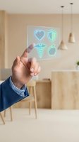 Male hand holding transparent glass panel with glowing neon healthcare icons including heart, shield, caduceus and apple in modern kitchen setting.