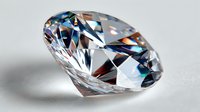 Brilliant cut diamond with rainbow light reflections on white background, showcasing luxury and precision craftsmanship for jewelry design.
