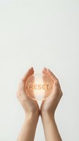 Hands cupping glowing reset button symbolizing fresh start, renewal and new beginning concepts for personal growth and transformation.
