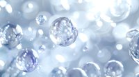 Transparent soap bubbles floating in soft blue atmosphere with dreamy bokeh light effect, creating ethereal underwater or sky-like ambiance.