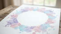 Watercolor floral wreath frame with soft pastel flowers in purple, pink and mint green on white paper, perfect for wedding invitations and stationery design.