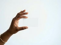 Hand holding transparent glass card isolated on white background, suitable for product mockups, business presentations, and design templates.