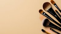 Professional makeup brushes and loose powder scattered on beige background, flat lay composition for beauty and cosmetics industry marketing.