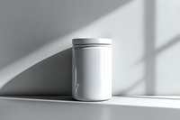 White cylindrical container with lid on shelf casting dramatic diagonal shadow in minimalist setting, clean modern product mockup for branding and packaging design.