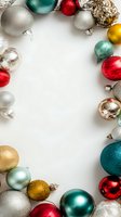 Colorful Christmas ornaments arranged in frame on white background with copy space for holiday greeting cards or social media posts.