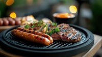 Grilled sausages and steak on black cast iron pan with fresh herbs, bokeh lights in background, close up view of juicy barbecue meat dinner.