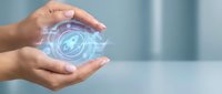Hands protecting glowing digital security shield with lock icon representing cybersecurity data protection and privacy technology concepts.