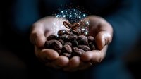 Magical coffee beans with glowing sparkles held in cupped hands against dark background, conceptual food photography showing growth and transformation.