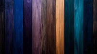 Multicolored wooden planks background with natural grain texture in dark blue, purple, brown and turquoise tones creating dramatic vertical stripes pattern.