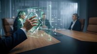 Businessman interacting with holographic data visualization and financial charts during corporate meeting in modern office environment.