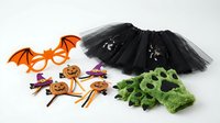 Halloween costume accessories set with black tulle skirt, orange bat mask, pumpkin picks and green monster gloves for spooky party dress up fun.