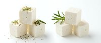 Stacked cubes of fresh feta cheese with herbs and seeds on white background, isolated for food packaging and culinary design use.