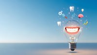 Creative dental care concept with lightbulb containing smile and floating medical icons against blue sky background for healthcare innovation campaigns.