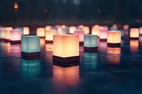 Glowing paper lanterns in cube shape scattered on dark surface create atmospheric mood with warm and cool light reflections in evening ambiance.