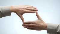 Professional hands forming frame gesture for creative vision and planning concepts in business and design applications.