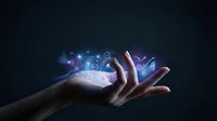 Human hand holding glowing digital charts and data analytics icons on dark background, representing futuristic technology and business intelligence.