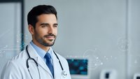 Confident male doctor with stethoscope smiling in modern medical office with digital healthcare technology interface overlay for telemedicine concepts.