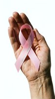 Hands gently holding pink awareness ribbon symbol for breast cancer support and healthcare advocacy on white background.