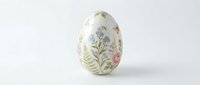 Hand-painted Easter egg with delicate floral motifs on white background, spring decoration for holiday celebrations and seasonal crafts.