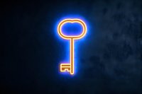 Glowing neon key sign with orange and blue light effect against dark background, symbolic representation of success and access for business concepts.