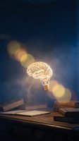 Glowing brain-shaped light bulb floating above books on wooden desk with warm bokeh lights representing creativity, innovation and bright ideas for education.
