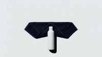 White cosmetic bottle with black cap isolated on light background, arranged with dark fabric for skincare product marketing and packaging design.