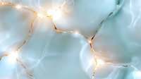 Glowing string lights creating warm illumination against soft blue fabric background for festive decoration and cozy atmosphere design projects.