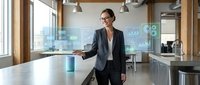 Professional businesswoman analyzing holographic data charts and graphs in modern office environment with digital technology interface displays.